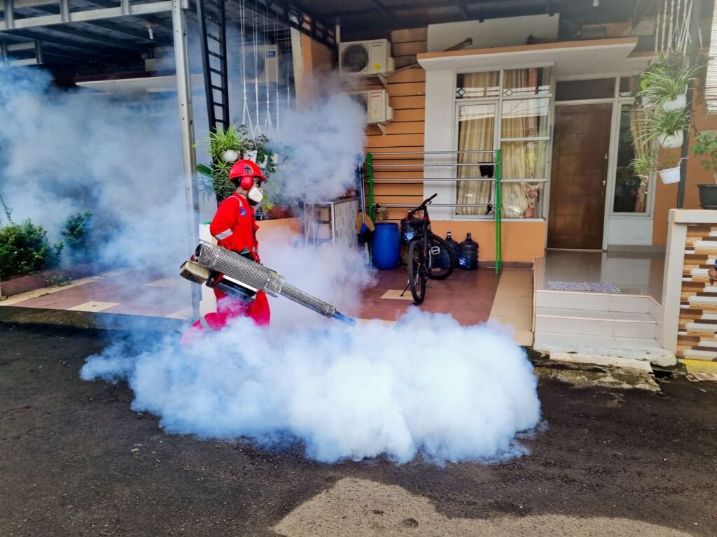 Pest control specialist working outside a home